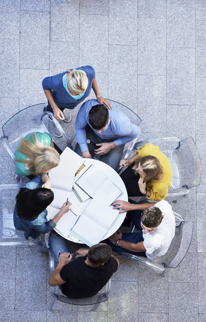 44369452 - top view,  group of students together  at school table working homework and have fun