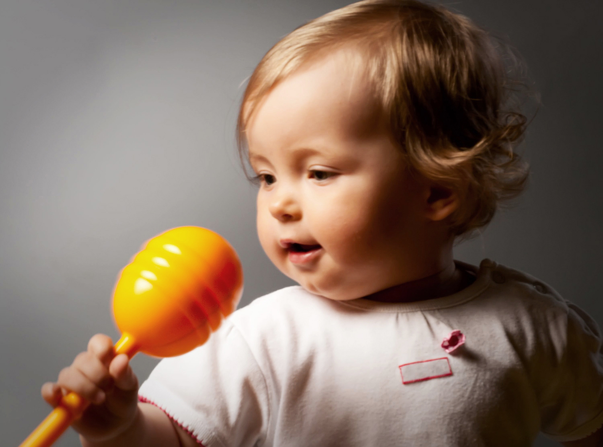 4956137 - small beauty girl and orange toy microphone. (soft focus)